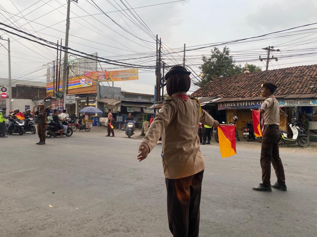 Foto Anggota pramuka mengamankan arus mudik